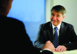 Smiling Man at a Table