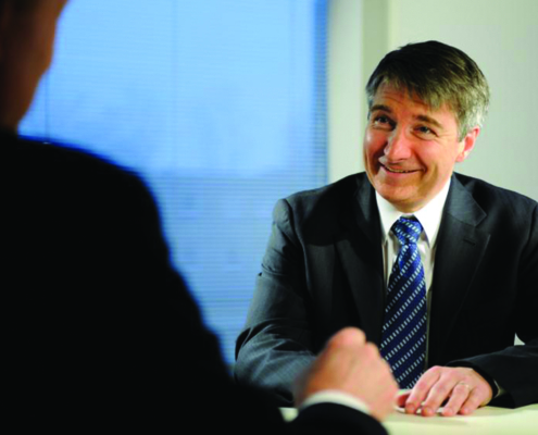Smiling Man at a Table